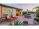 Relaxing backyard features lounge chairs, outdoor dining, built-in grill, lush landscaping and water feature at 37148 N Stoneware Dr, Queen Creek, AZ 85140