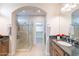 Well-appointed bathroom featuring a glass-enclosed shower, dual sinks, and granite countertops at 37148 N Stoneware Dr, Queen Creek, AZ 85140