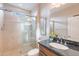 Elegant bathroom featuring a glass-enclosed shower, granite countertop, tile floors and updated fixtures at 37148 N Stoneware Dr, Queen Creek, AZ 85140