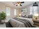 Bright bedroom with plantation shutters, a ceiling fan, neutral decor and stylish furnishings at 37148 N Stoneware Dr, Queen Creek, AZ 85140