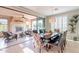 Bright dining room with large sliding glass doors, fireplace and patio access, and plantation shutters at 37148 N Stoneware Dr, Queen Creek, AZ 85140