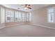 Spacious empty bedroom with carpet, plantation shutters, and a ceiling fan awaiting your personal touch at 37148 N Stoneware Dr, Queen Creek, AZ 85140