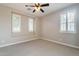 Spacious empty bedroom with carpet, plantation shutters, and a ceiling fan awaiting your personal touch at 37148 N Stoneware Dr, Queen Creek, AZ 85140