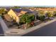 Inviting single-story home featuring mature landscaping, solar panels, and a charming brick-paved driveway at 37148 N Stoneware Dr, Queen Creek, AZ 85140