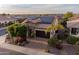 Beautiful single-Gathering home featuring a well-maintained yard, mature trees, and solar panels at 37148 N Stoneware Dr, Queen Creek, AZ 85140