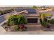 Beautiful single-story home with solar panels, brick driveway, desert landscaping, and a two-car garage at 37148 N Stoneware Dr, Queen Creek, AZ 85140