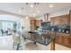 Spacious kitchen with a large island, stainless appliances, pendant lighting, and an adjacent dining space at 37148 N Stoneware Dr, Queen Creek, AZ 85140