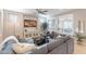 Comfortable living room with shutters, neutral walls, large windows, and an oversized sectional sofa at 37148 N Stoneware Dr, Queen Creek, AZ 85140
