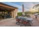 Inviting outdoor patio featuring a dining area and built-in grill, ideal for relaxing and enjoying the serene surroundings at 37148 N Stoneware Dr, Queen Creek, AZ 85140