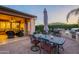 Outdoor patio features a dining area, grill and lounge seating with comfortable seating and ceiling fan at 37148 N Stoneware Dr, Queen Creek, AZ 85140