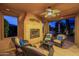 Inviting covered patio with fireplace, seating, and open view to the outdoor dining area at 37148 N Stoneware Dr, Queen Creek, AZ 85140