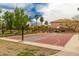 Outdoor basketball court with hoops, painted lines, and landscaping at 3848 S Coach House Dr, Gilbert, AZ 85297