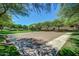 Outdoor basketball court with benches surrounded by lush greenery and blue sky at 3848 S Coach House Dr, Gilbert, AZ 85297