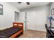 Cozy bedroom featuring carpet flooring, closet, ceiling fan, and natural light, with a simple design at 3848 S Coach House Dr, Gilbert, AZ 85297