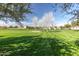 Expansive community green with mature trees, walking paths and gathering gazebo at 3848 S Coach House Dr, Gilbert, AZ 85297