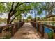 Wooden pier on the community lake, featuring charming lampposts and lush greenery at 3848 S Coach House Dr, Gilbert, AZ 85297