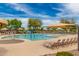 Fun community pool area with colorful water features, umbrellas, and lounge chairs at 3848 S Coach House Dr, Gilbert, AZ 85297