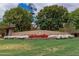 Community sign with windmill detail, lush greenery and colorful flowers at 3848 S Coach House Dr, Gilbert, AZ 85297