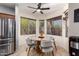 Cozy dining area with a round table, four chairs, tile flooring, and natural light from the windows at 3848 S Coach House Dr, Gilbert, AZ 85297