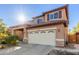 Beautiful two-story home boasts a welcoming entrance, manicured landscape, and a two-car garage at 3848 S Coach House Dr, Gilbert, AZ 85297