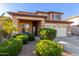 Inviting two-story home boasts a welcoming entrance, well-manicured shrubs, and a two-car garage at 3848 S Coach House Dr, Gilbert, AZ 85297