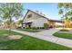 Striking venue with beautiful landscaping, sidewalks, and a covered drive-through with hanging lights at 3848 S Coach House Dr, Gilbert, AZ 85297