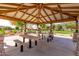 Covered picnic area featuring stone accents, ample seating, and community green space for relaxation and social gatherings at 3848 S Coach House Dr, Gilbert, AZ 85297