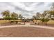 Community playground with slides and play equipment with lush landscaping for residents to enjoy at 3848 S Coach House Dr, Gilbert, AZ 85297
