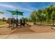 Community playground features a shaded play structure, swings, and benches for relaxation at 3848 S Coach House Dr, Gilbert, AZ 85297