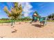 A fun playground area with slides and climbing structures, set in a safe, sandy environment for active play at 3848 S Coach House Dr, Gilbert, AZ 85297