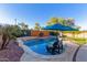 Sparkling backyard pool boasts a waterfall feature, lush landscaping, and comfortable seating for relaxing and entertaining at 3848 S Coach House Dr, Gilbert, AZ 85297
