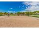 Sandy volleyball court on a clear day with trees and other recreational facilities in the background at 3848 S Coach House Dr, Gilbert, AZ 85297
