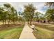 Take a stroll on the paved walking path with lush landscaping and a bench for rest and relaxation at 3848 S Coach House Dr, Gilbert, AZ 85297