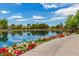 Picturesque walking path with colorful flowers lining the community lake at 3848 S Coach House Dr, Gilbert, AZ 85297