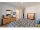 The well-lit bedroom reveals coordinated furniture and decor, extending towards a glimpse of the en-suite bathroom at 4077 S Sabrina Dr # 25, Chandler, AZ 85248