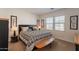 A well-lit bedroom features a bed with patterned linens, alongside stylish decor and natural light from the window at 4077 S Sabrina Dr # 25, Chandler, AZ 85248