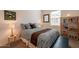 Cozy bedroom featuring a comfortable bed, matching side tables with lamps, and modern shelving and decor at 4077 S Sabrina Dr # 25, Chandler, AZ 85248