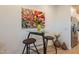 Cozy dining area with a modern table, stools, and colorful floral artwork on the wall at 4077 S Sabrina Dr # 25, Chandler, AZ 85248