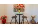 Charming dining area featuring a modern table with stools and colorful floral artwork at 4077 S Sabrina Dr # 25, Chandler, AZ 85248