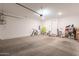 A clean and spacious garage featuring concrete floors, white walls, and ample storage area at 4077 S Sabrina Dr # 25, Chandler, AZ 85248