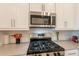 Close-up of a modern kitchen with stainless steel appliances and light gray countertops at 4077 S Sabrina Dr # 25, Chandler, AZ 85248