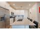 Open-concept kitchen with stainless steel appliances, island with seating, and white cabinetry at 4077 S Sabrina Dr # 25, Chandler, AZ 85248