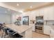 Bright kitchen with stainless appliances, island seating, white cabinets, open to dining area at 4077 S Sabrina Dr # 25, Chandler, AZ 85248