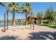 Community playground featuring swings with views of the lake, fountain, and palm trees at 4077 S Sabrina Dr # 25, Chandler, AZ 85248