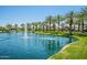 Scenic community pond featuring a fountain and swaying palm trees in the background at 4077 S Sabrina Dr # 25, Chandler, AZ 85248