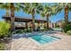 Community spa surrounded by lush landscaping with a nearby pool, ramada and tropical palm trees at 4077 S Sabrina Dr # 25, Chandler, AZ 85248