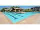 Community pool featuring lane markers, sun deck with lounge chairs, and shade umbrella at 4077 S Sabrina Dr # 25, Chandler, AZ 85248