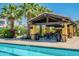Relaxing community pool area with shaded picnic tables and lush tropical landscaping at 4077 S Sabrina Dr # 25, Chandler, AZ 85248