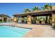 Community pool featuring a covered ramada with seating and a dining table at 4077 S Sabrina Dr # 25, Chandler, AZ 85248