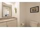 Stylish powder room with neutral color palette, mirror, and bird-of-paradise art at 4077 S Sabrina Dr # 25, Chandler, AZ 85248